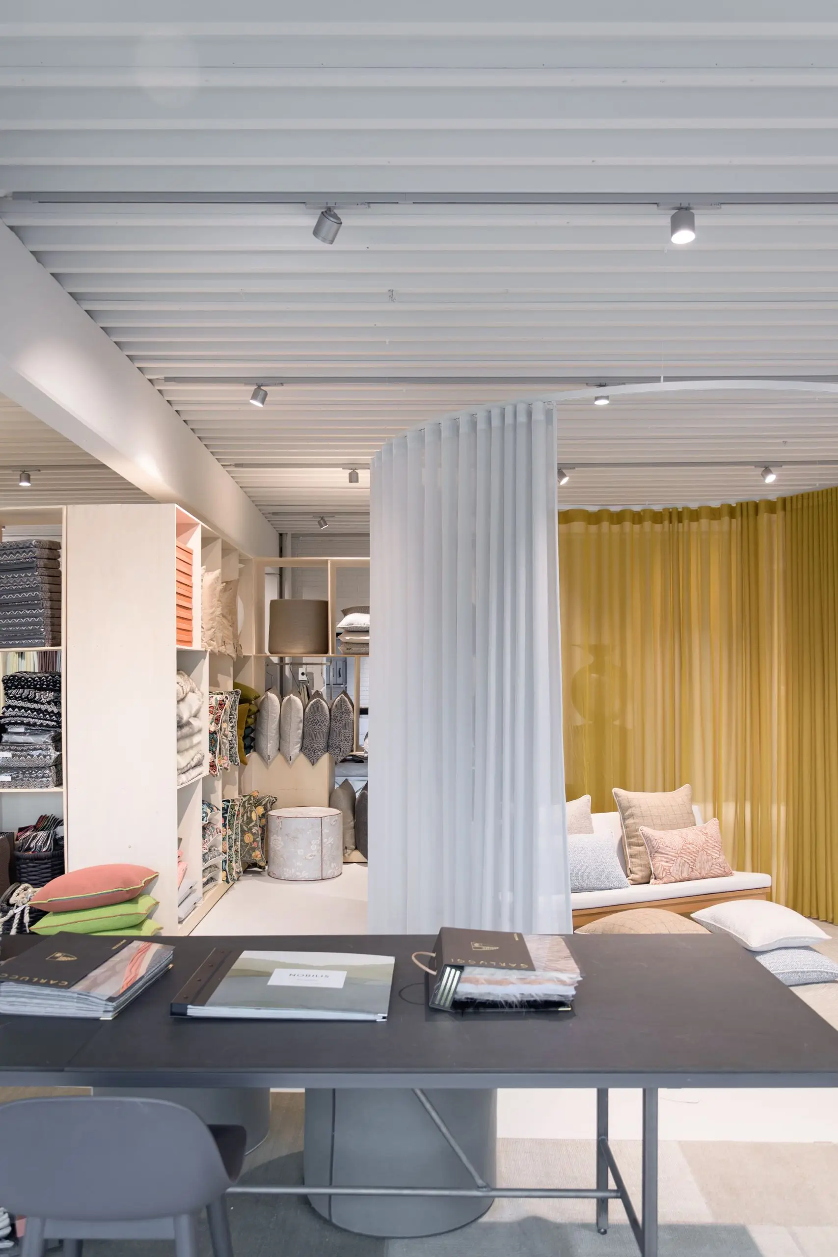 Design Gardiner showroom with curtains and sample table