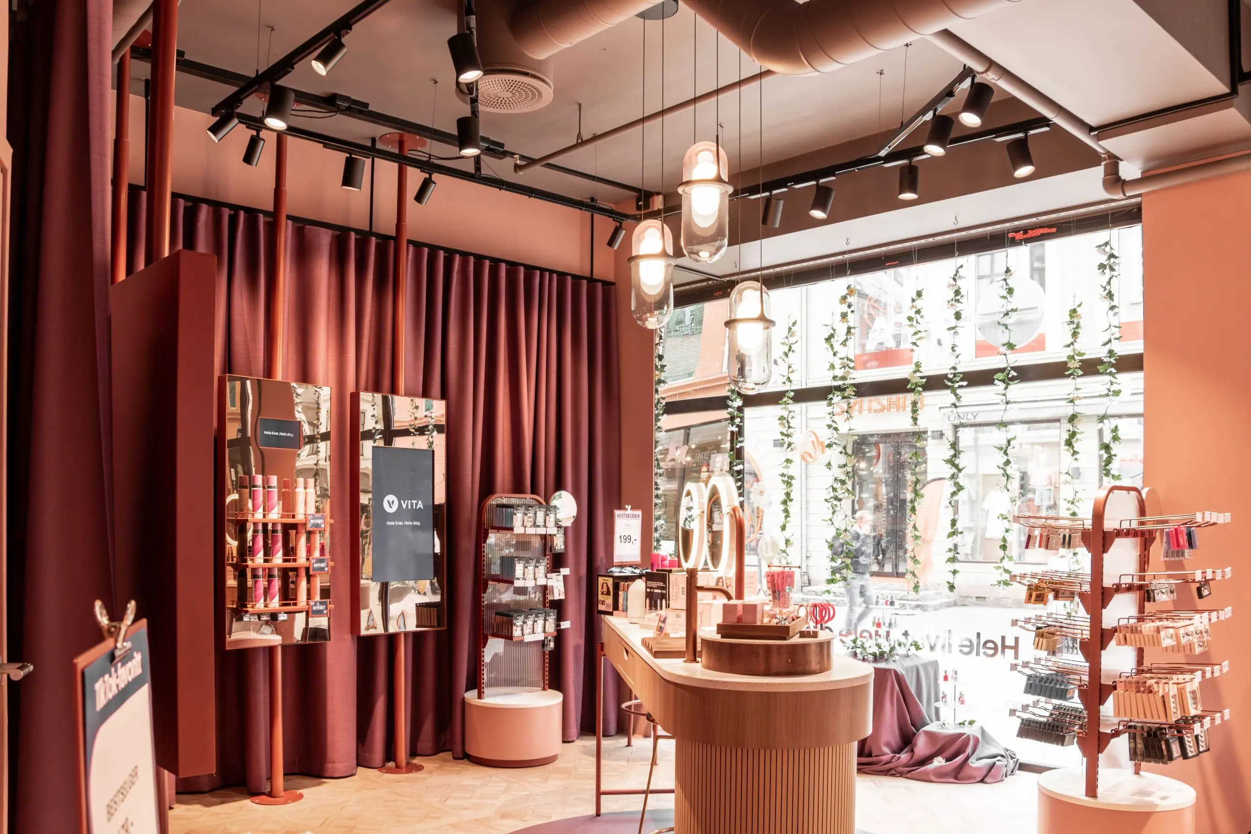 Retail interior with warm red curtains and pendant lighting